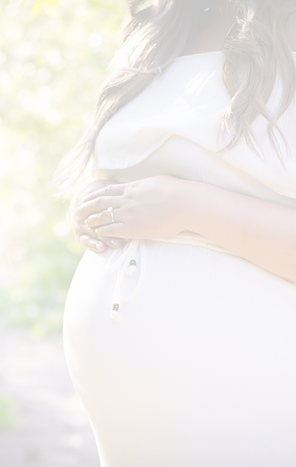 pregnant woman standing near green plant