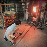 Clearing-out-charcoal-at-the-lower-air-vent-during-wood-firing-pan-yu-feng-huang-kaun-lun.