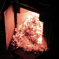 Clearing-out-charcoal-at-the-lower-air-vent-during-wood-firing-Feng-Tea-N-Pottery-pan-yu-f