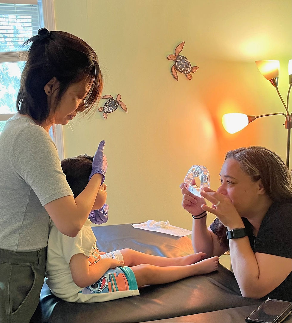 Yichien treating a young child as his mother keeps him focused.