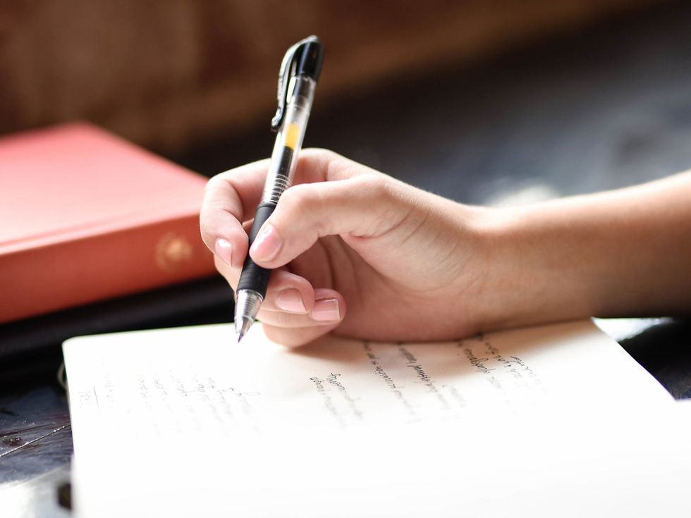 An ADHD person writing Strengths-Based Journaling in a notebook