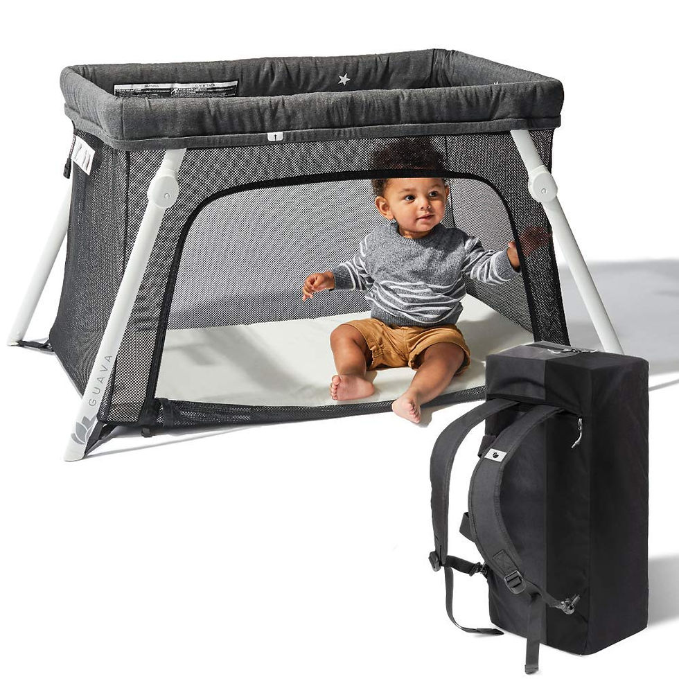 Baby sitting up in Guava Lotus travel crib