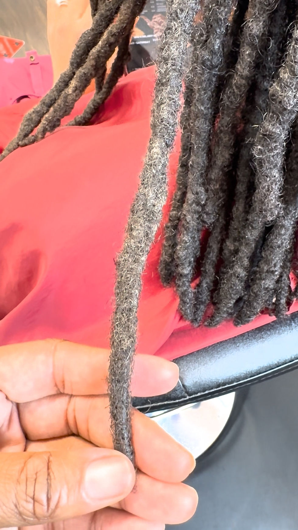 After loc repair showing two traditional locs combined into one continuous loc using a reconstruction technique.