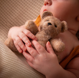 Close-up of baby feet wrapped in cozy knit – Gloucester newborn photography session.