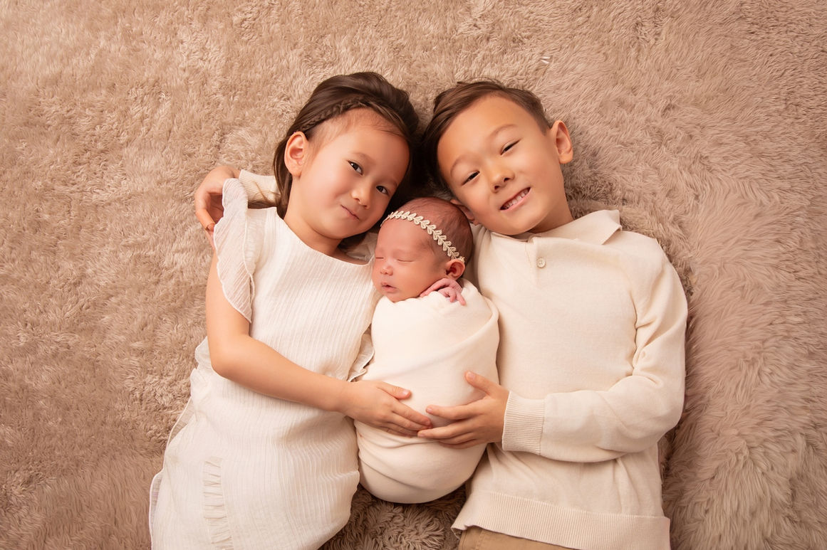 Newborn baby posed safely and sleeping during a professional photoshoot in Gloucester