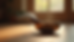 Eye-level view of a crystal singing bowl on a wooden floor in a softly lit room