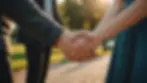 Eye-level view of a couple holding hands outdoors