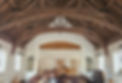 Memorial Hall with exposed wooden ceiling beams looking towards the stage