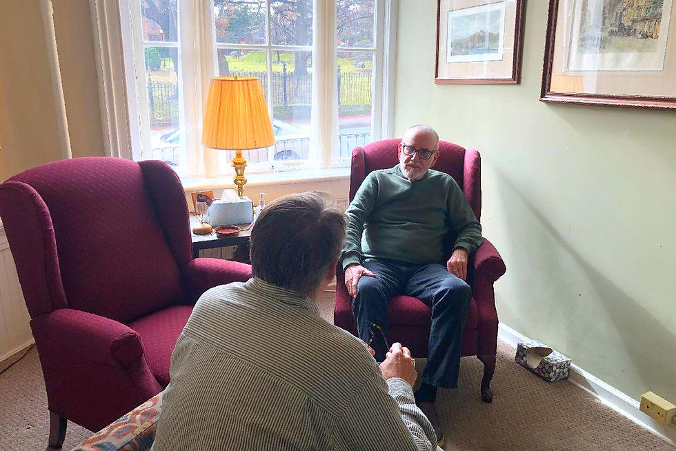 Dr Arbaugh in a Integrative Dialogue conversation sitting in comfortable armchairs.