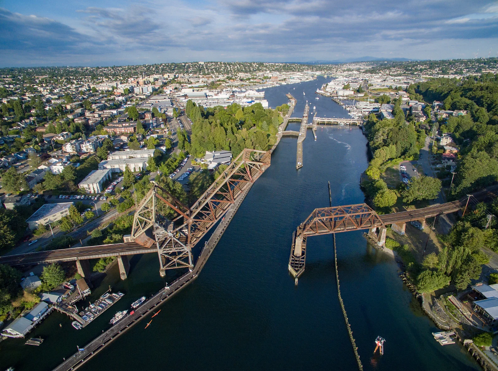 Aerial photo of Ballard Locks and neighborhood in Seattle, showing waterways, bridges, and homes in a popular short-term rental area.