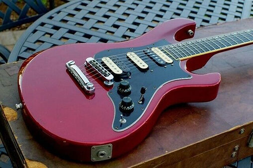 1981 Gibson Victory MVX Electric Guitar in Candy Apple Red with Gibson branded hard case. Well-played and roadworn, but still a superb, versatile and rare players instrument. £1,399 or nearest offer.