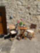 A photograph of the exterior of Johnnies Cottage, Bainbridge. The photograph focuses on the bistro s