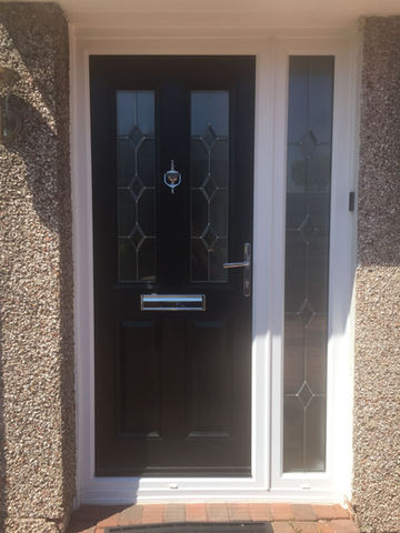 A black door with glass design