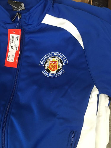 A blue and white jacket with a football club logo