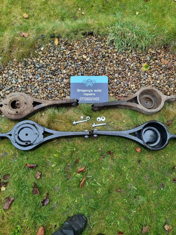 Old and new black rear arms on a grass
