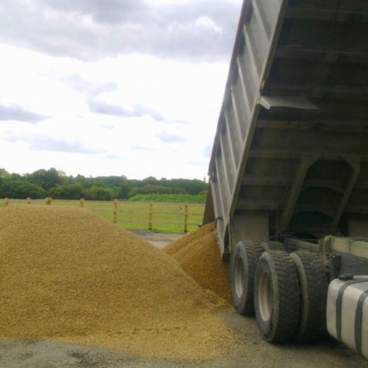 A large truck unloading material for driveway construction