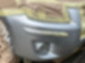 A close-up of a car with a sheet covering it
