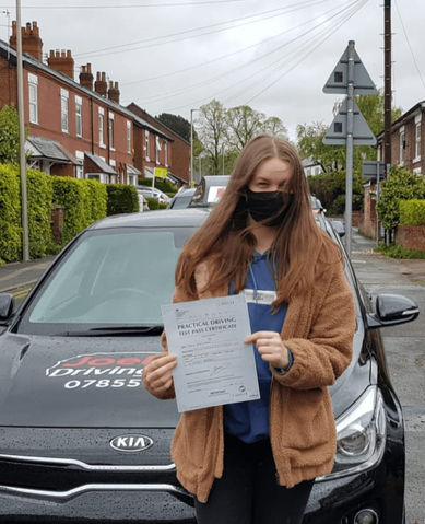 a girl is wearing mask and posing with the certificate