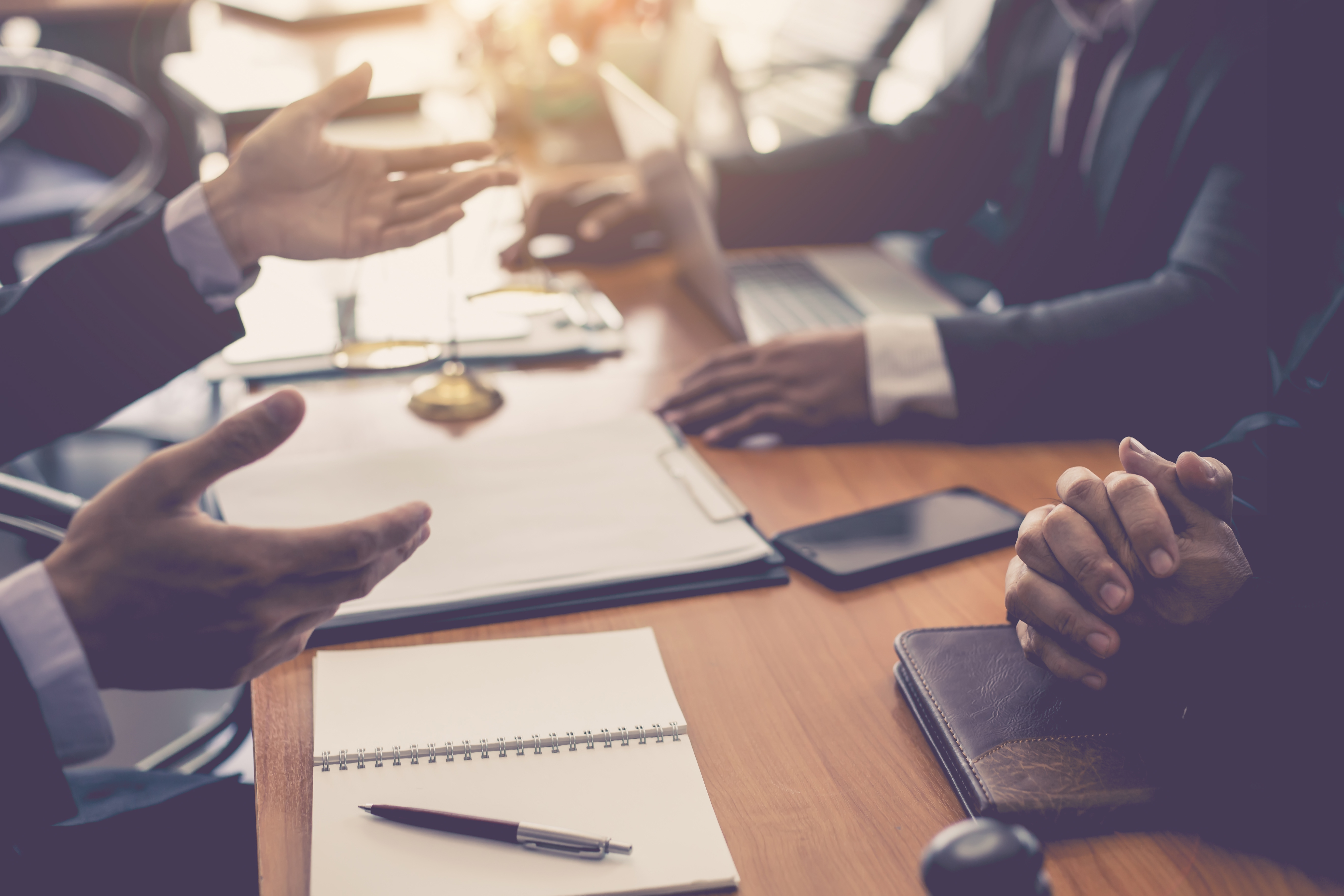 Attorneys consulting with clients at a table