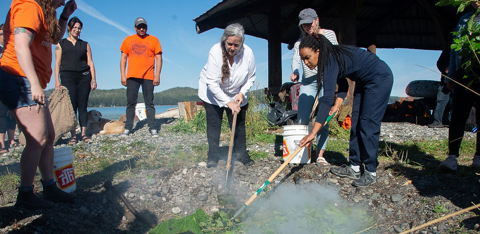 Photo by Kwakiutl Health Centre: Community members and guests prepare a cook pit in Tsaxis, coordinated by Kwakiutl Health Centre, which is now stewarding the Mount Waddington United Way Food Hub Project.