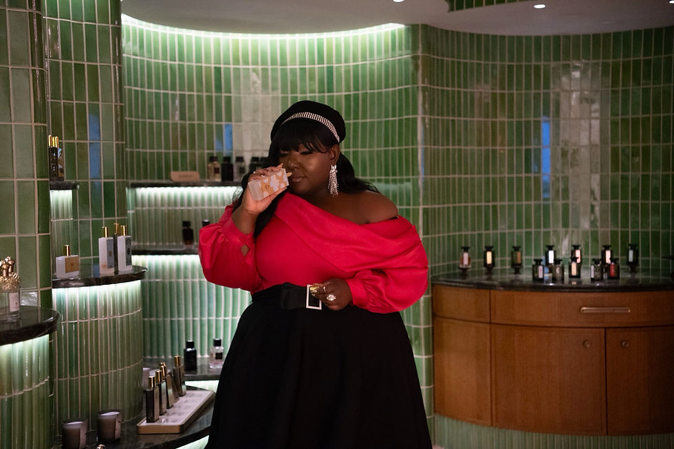 fashion creator smelling perfume at printemps
