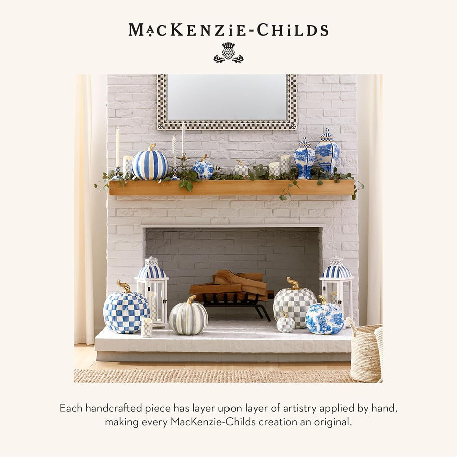 Fireplace decorated with blue and white pumpkins, candles