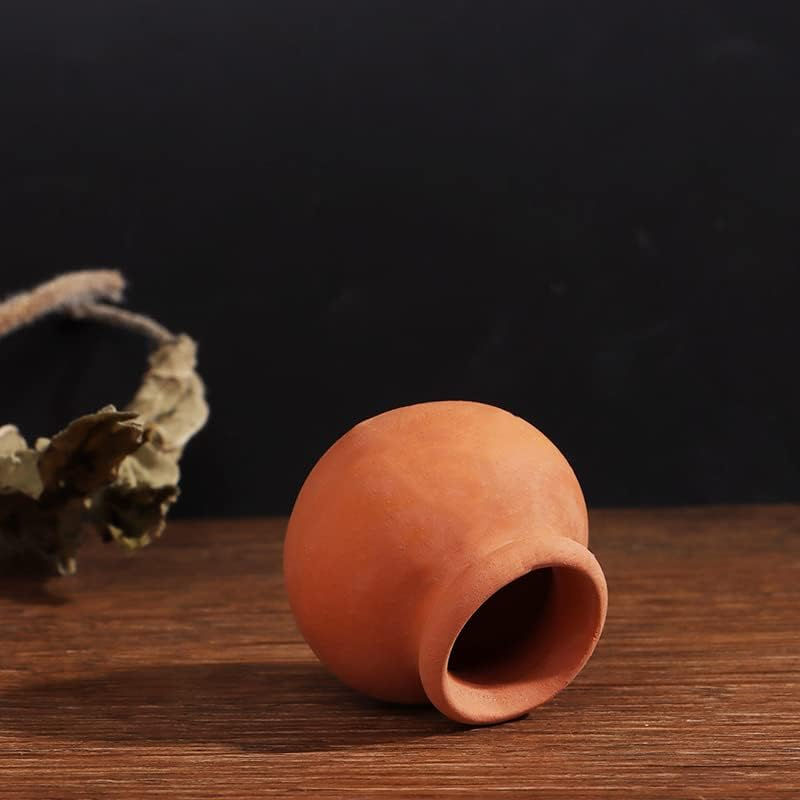 Small terracotta pot on wooden surface