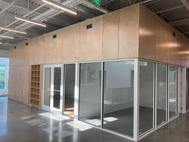 Crux South Austin 2nd floor offices and lounge with finished wall panels. commercial millwork by Welborn Woodworks