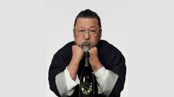 Takashi Murakami posing with a bottle of Dom Perignon