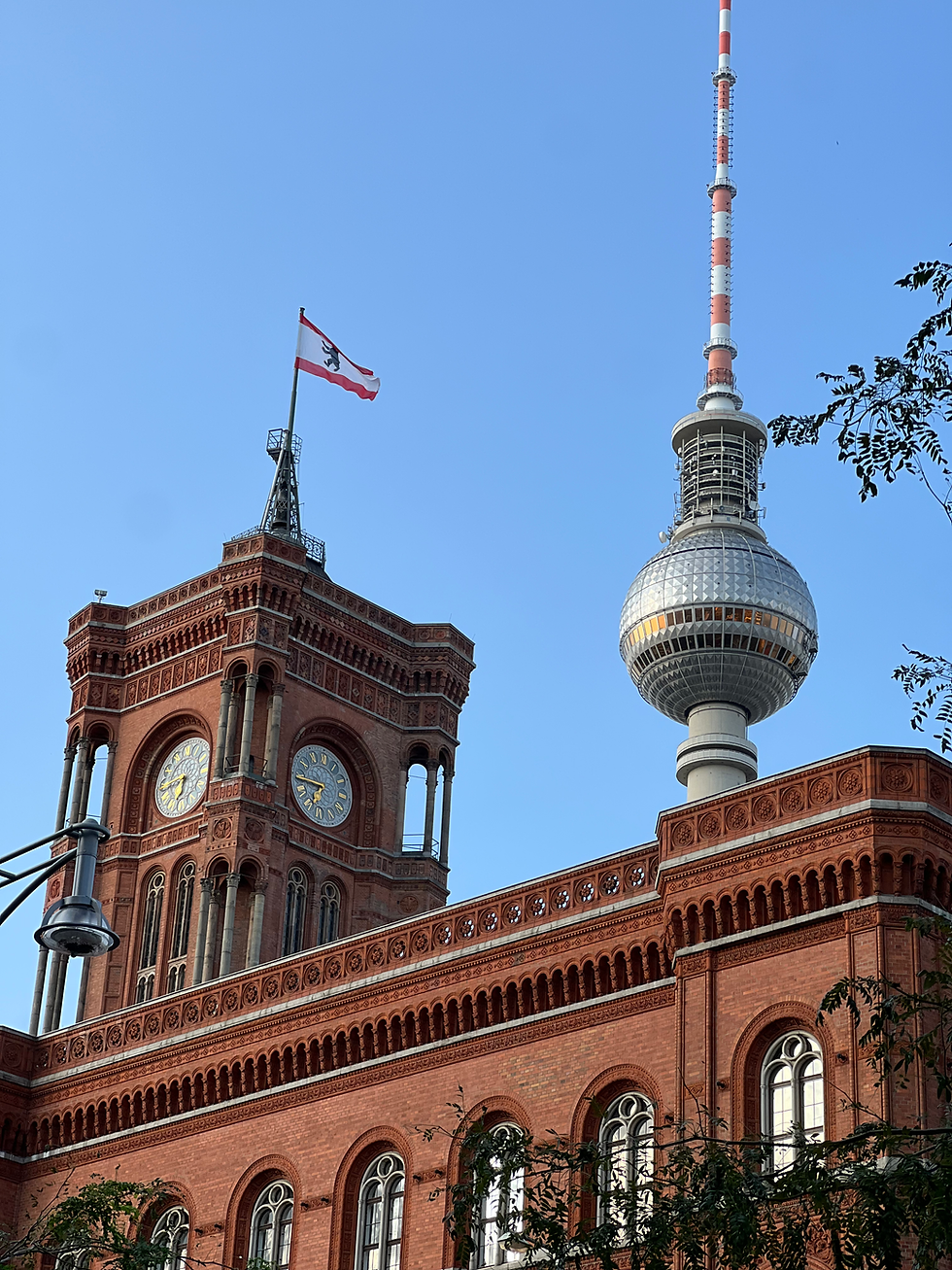 The iconic Rotes Rathaus and Fernsehturm stand proudly under the clear Berlin sky, showcasing the city's rich architectural heritage.