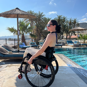 woman in wheelchair at a pool in Crete
