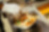 A bowl of mac + cheese with various toppings