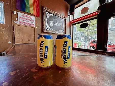 Two cans of Twisted Tea Original on a bartop