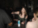 A female bartender pouring two cocktails