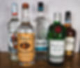 A bottle of Captain Morgan, Tito's Vodka, El Jimador, Tanqueray, and Old Forester