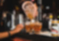 A bartender's hands pouring a drink