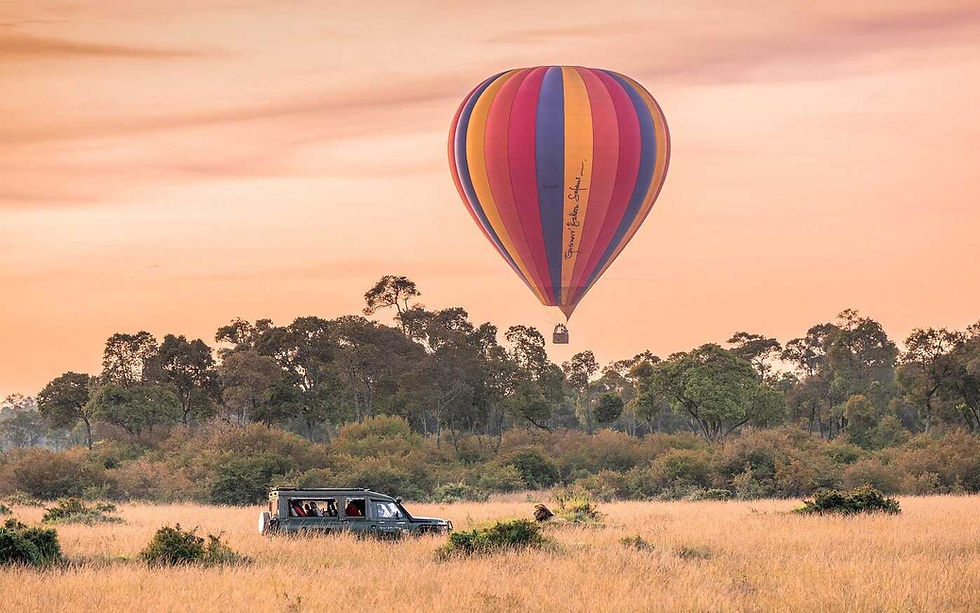 Hot air balloon floating over Masai Mara at dawn