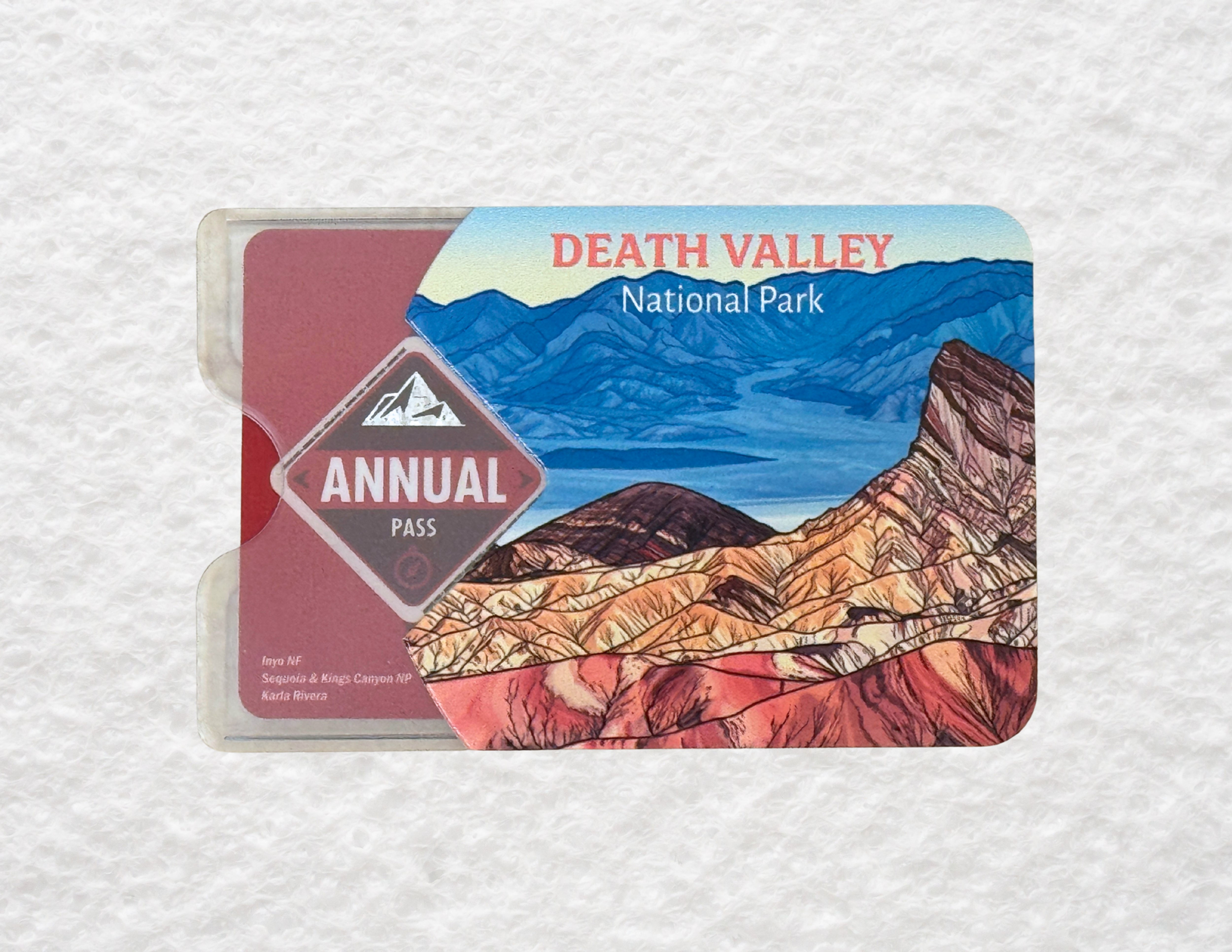 A translucent plastic sleeve for America the Beautiful National Park passes featuring a design of Death Valley National Park