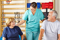 Happy physiotherapist giving senior grou