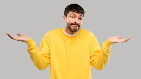 Yellow jumper man shrugging