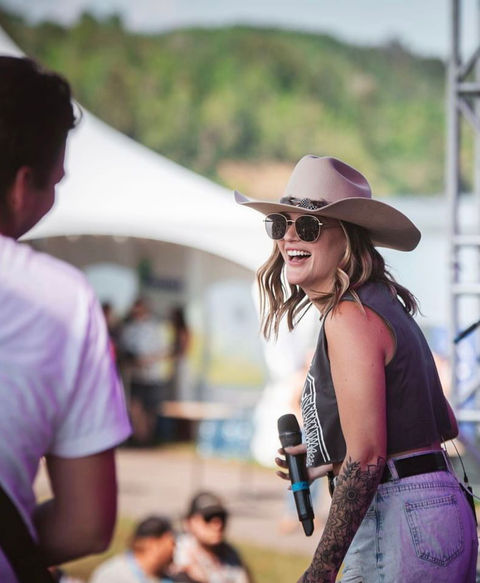 Catie St. Germain performing and laughing on stage