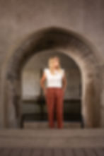 Beth Blackmore standing in archway of stone building