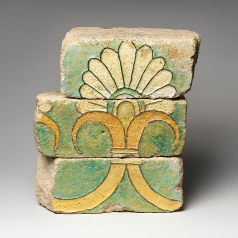 Three glazed brick fragments stacked to form a palmette motif from the Achaemenid period.