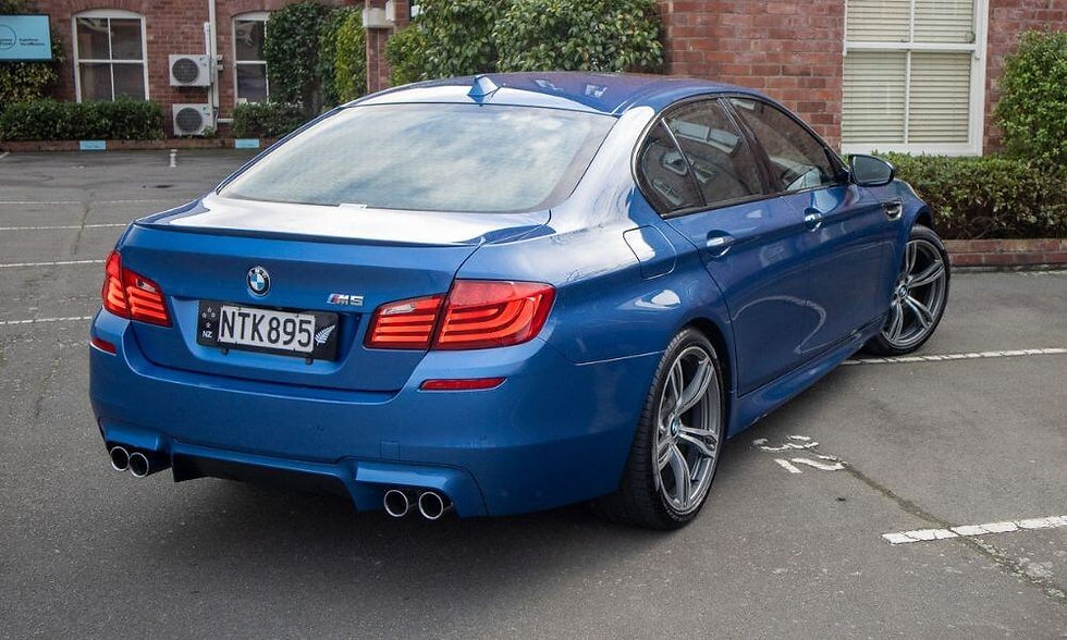 Blue BMW M5 sports car with New Zealand license plate, perfect example of a vehicle owners may choose to trade in or sell privately when upgrading to a new car in NZ.