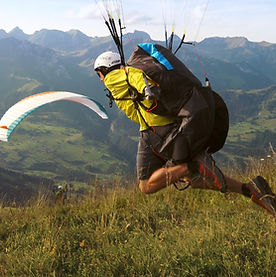Paraglider pilot launching