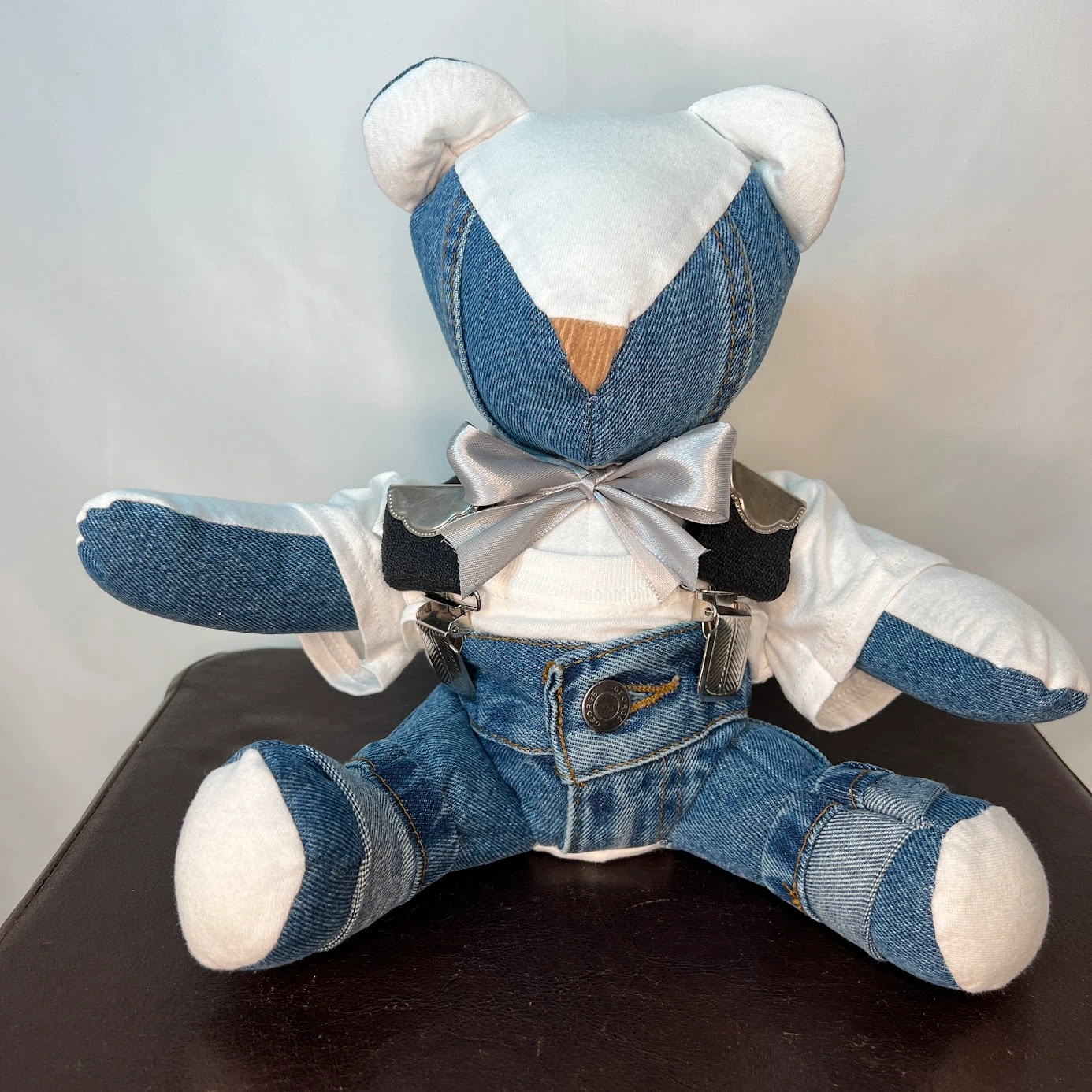 A cute custom memory bear with suspenders and jeans that celebrate the life of a grandpa who passed.