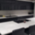 White kitchen surfaces, stone worktops, Carrara Quartz marble effect with an Island, full splashback in stone, white and Black kitchen design. North west london fabricators and suppliers NW