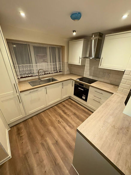 cream units, wooden worktops and wood flooring in a kitchen