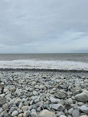 view by the sea with grey pebbles