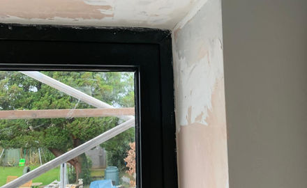 Painting plastered walls around window
